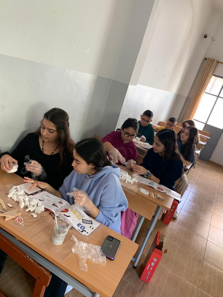 Children and adults taking part in a clay craft workshop