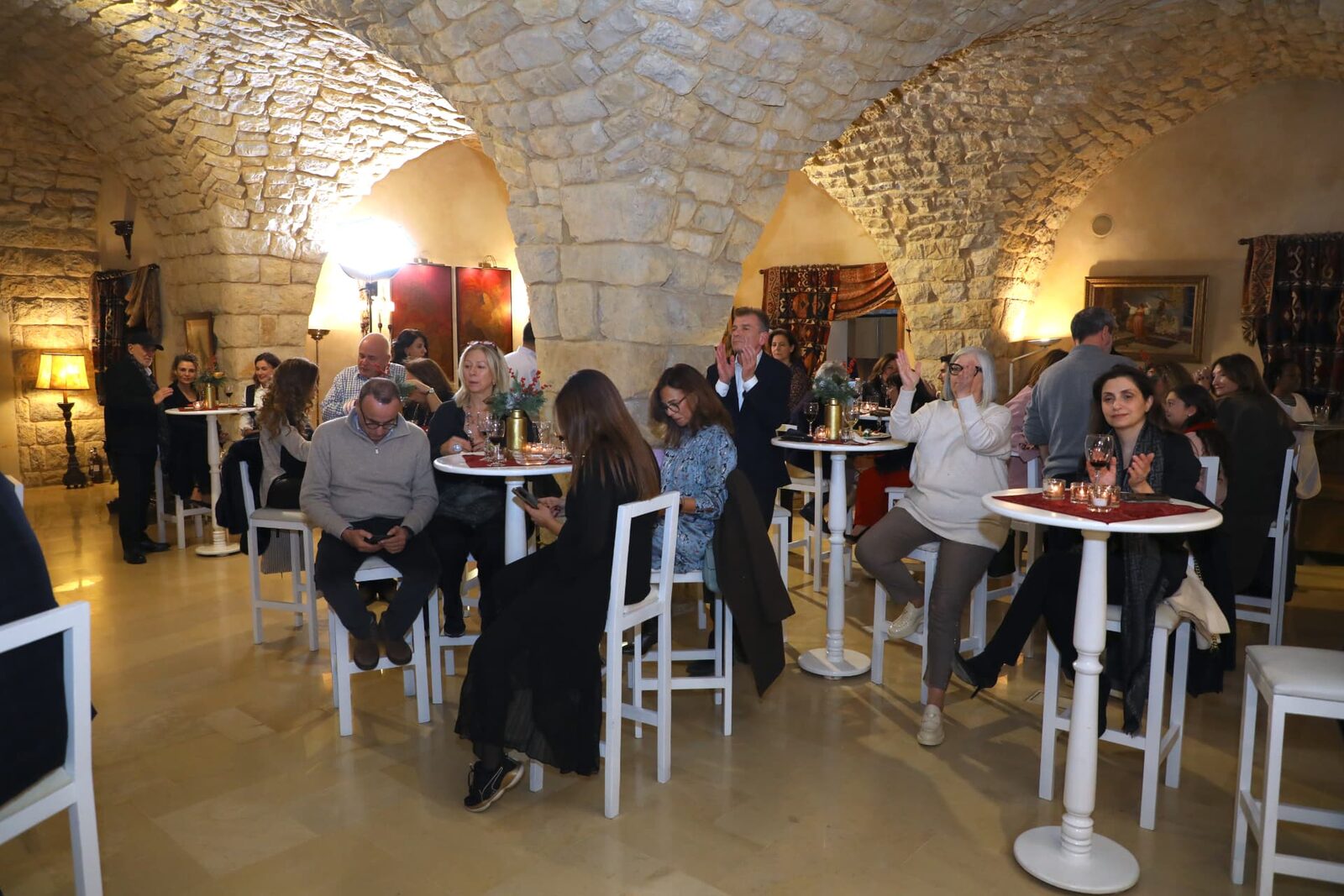 Guests enjoying an evening in the vaulted stone hall
