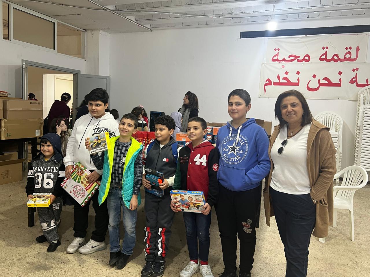 Children and volunteers with gifts at a community gathering