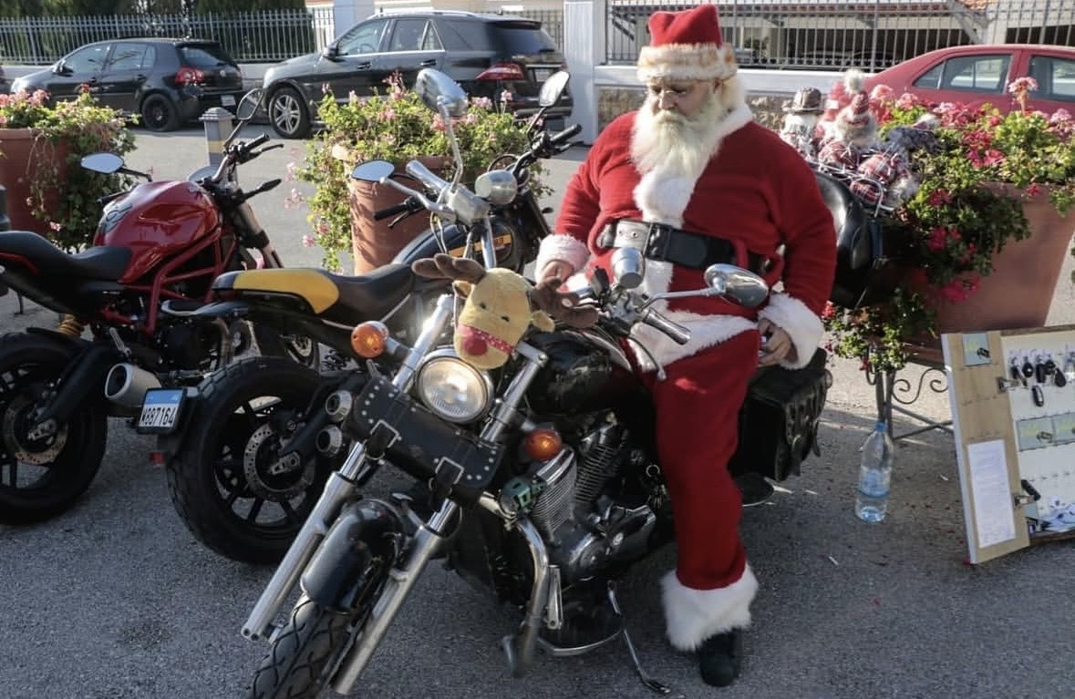 Santa Claus poses on a motorcycle before the 2019 market