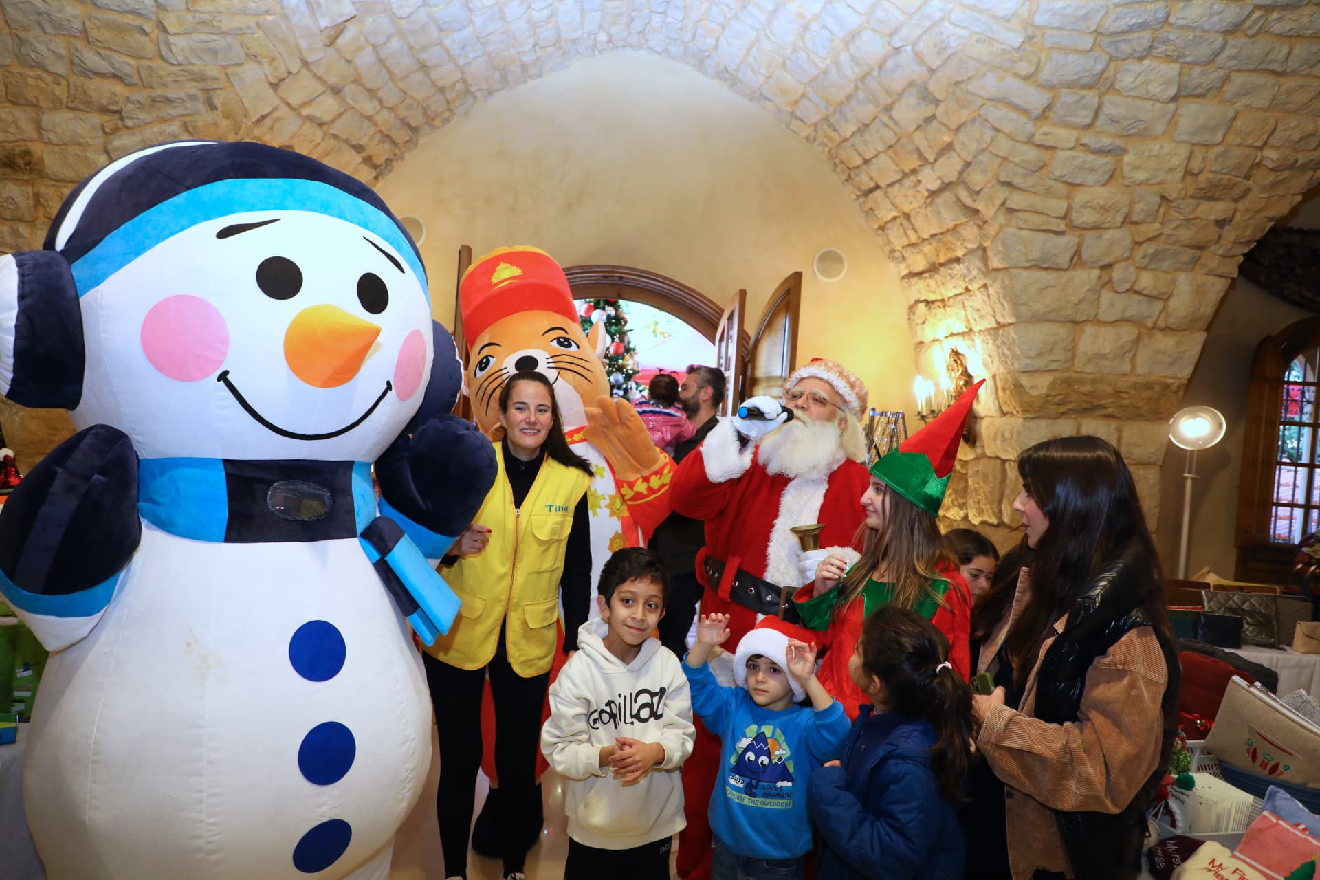 Santa, an inflatable snowman and costumed hosts greet children at the entrance