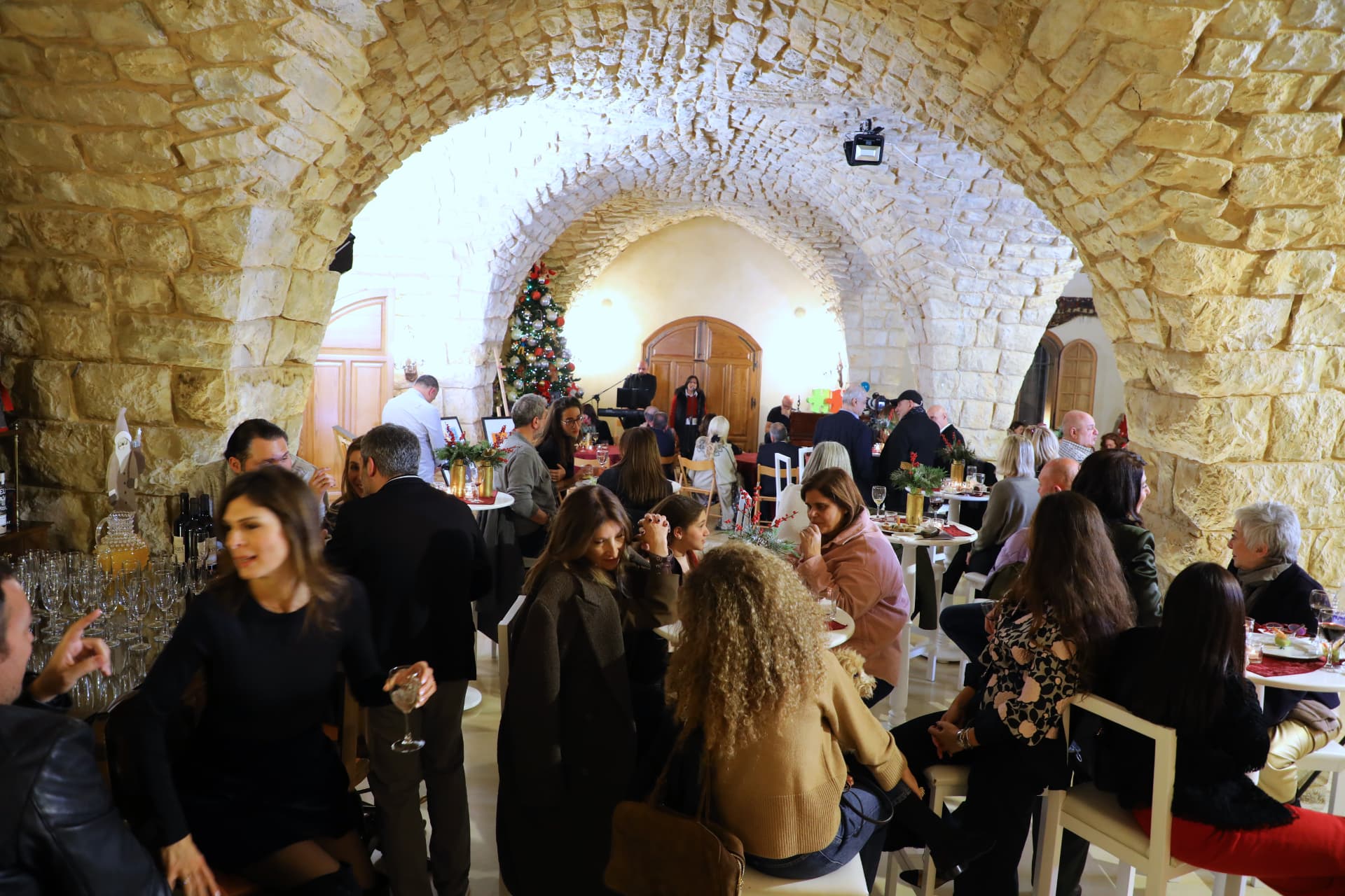 Guests at the first Christmas Aperitivo in the vaulted stone hall